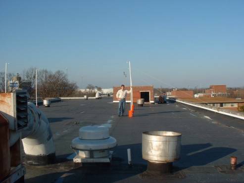 Chuck Higgins with a set of Radio JOVE dipoles on the roof of a building