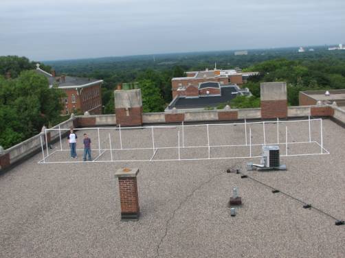 A large Yagi antenna mounted on PVC pipes on a rooftop