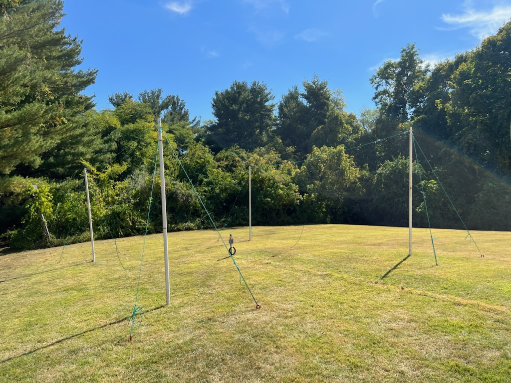 A photo of two horizontal
  antennas strung between four vertical posts.